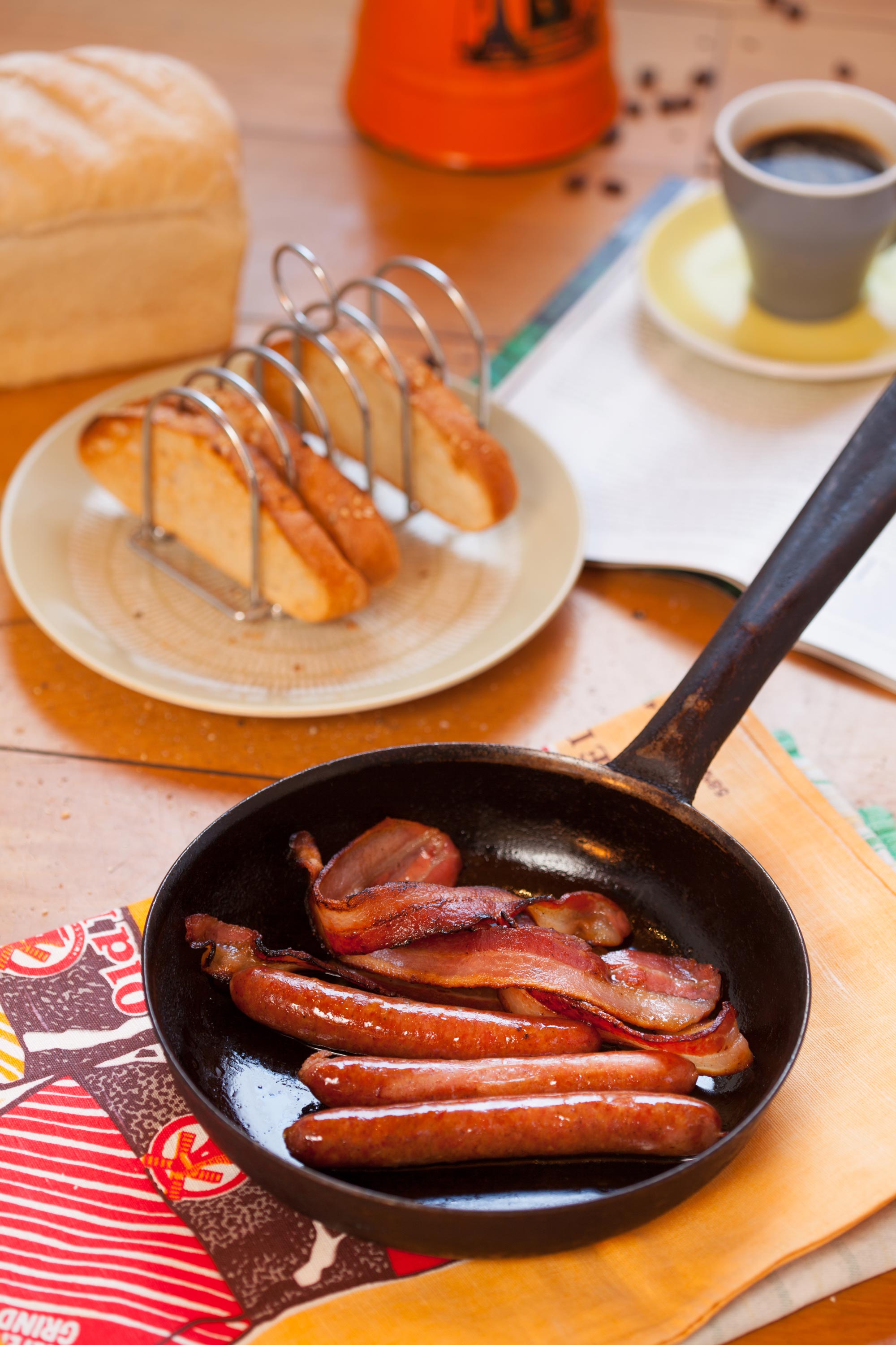 Bacon and sausages on a dish with condiments