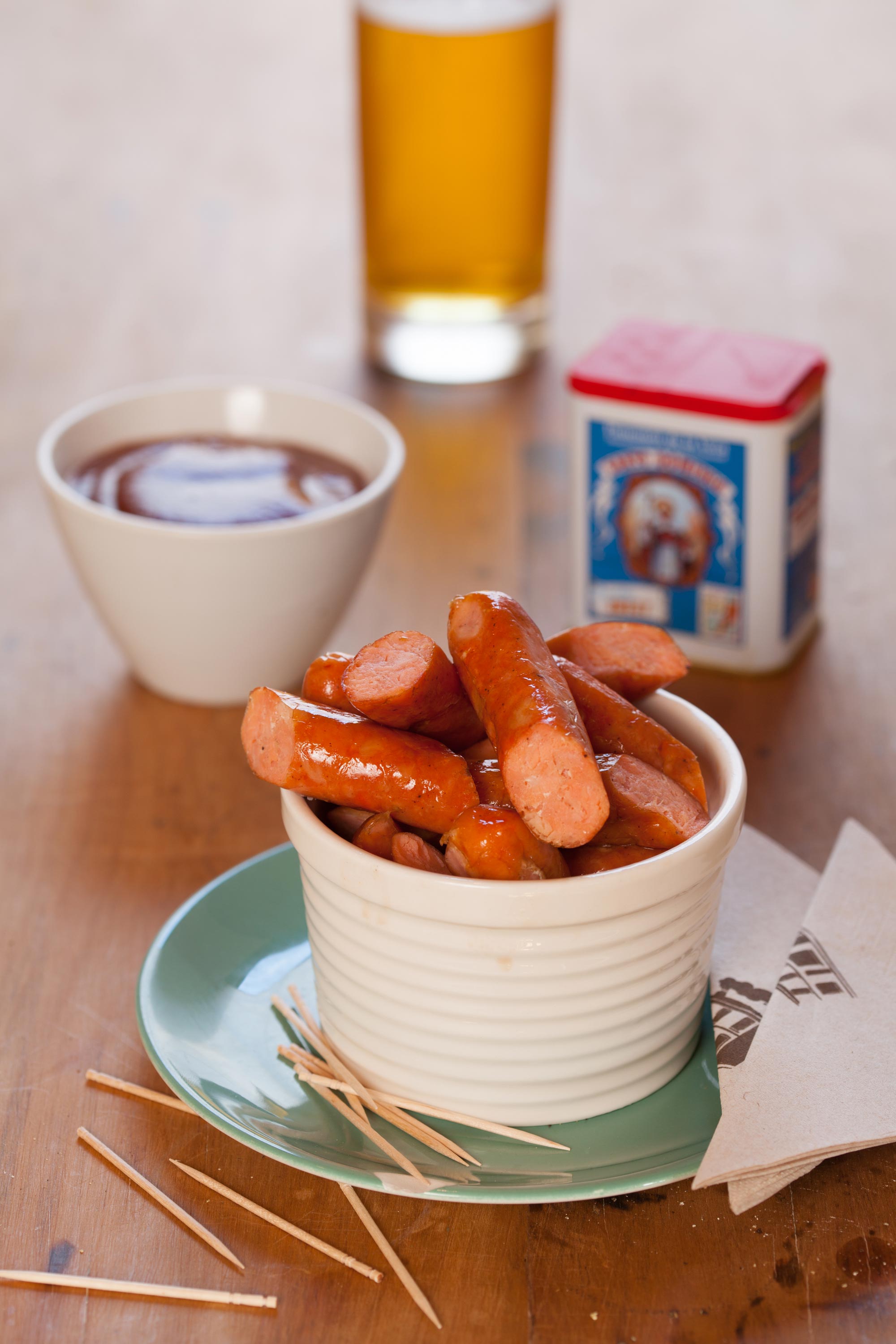 Salmon sausage cit into 1/3rds in a bowl with a dip